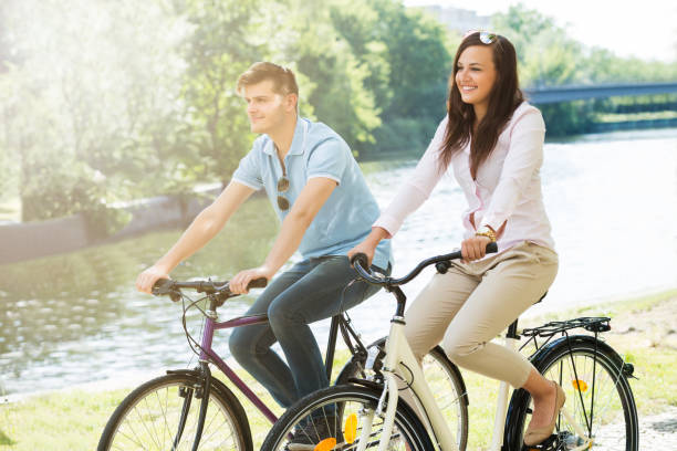 istock Smiling Couple On Bicycle In The Park 847833224