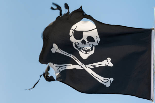 istock Torn pirate flag against the blue sky 847838838