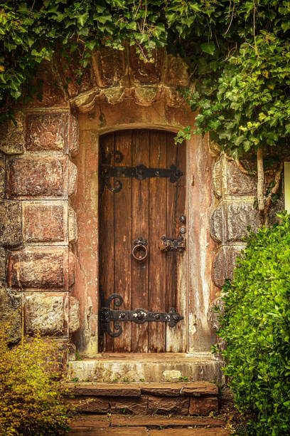 istock wooden door in stone wall 847843264
