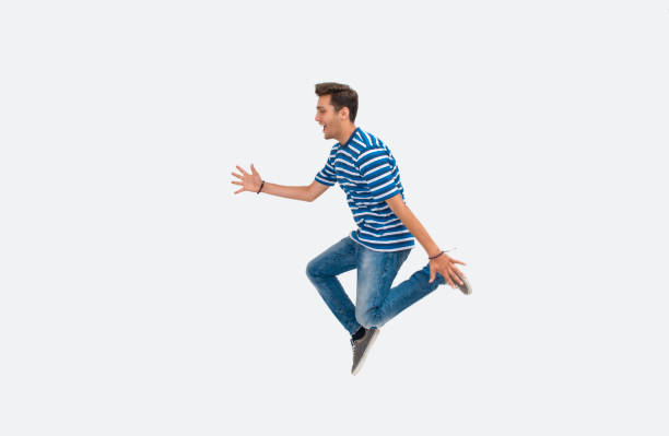 istock Portrait of laughing young man jumping on white background 847845886