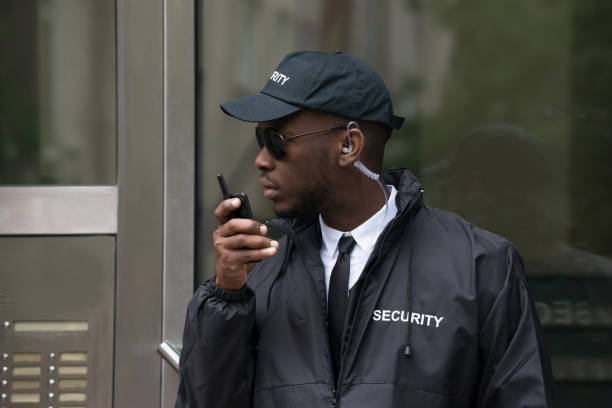 Security Guard Talking On Walkie-Talkie Portrait Of Young African Male Security Guard Talking On Walkie-Talkie security guard photos stock pictures, royalty-free photos & images