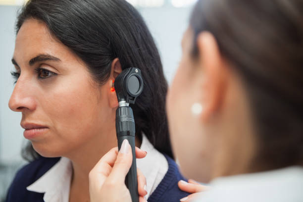 istock Doctor using otoscope to check womans ear 847850074