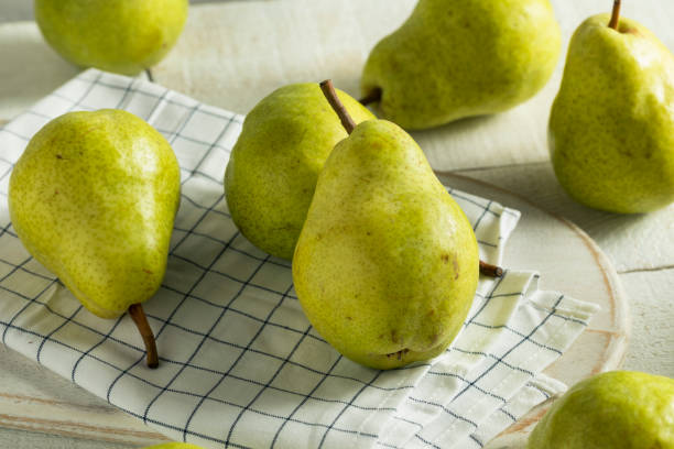 Raw Green Organic Bartlett Pears Raw Green Organic Bartlett Pears Ready to Eat bartlett pear stock pictures, royalty-free photos & images