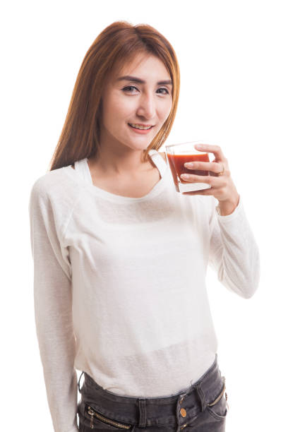 istock Young Asian woman drink tomato juice. 847853806
