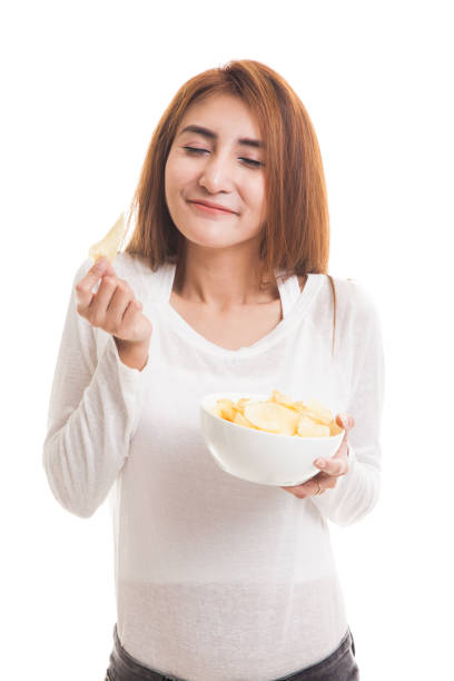istock Young Asian woman eat potato chips. 847854064
