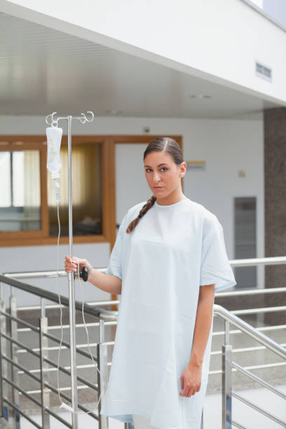 istock Female patient holding a drip stand 847867588
