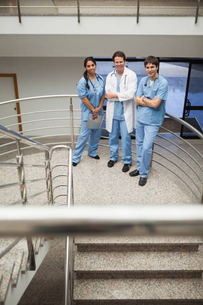 istock Doctor and two nurse standing on the stairs 847879510