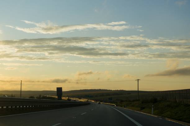 istock Misty morning sunrise on the road. 847883734