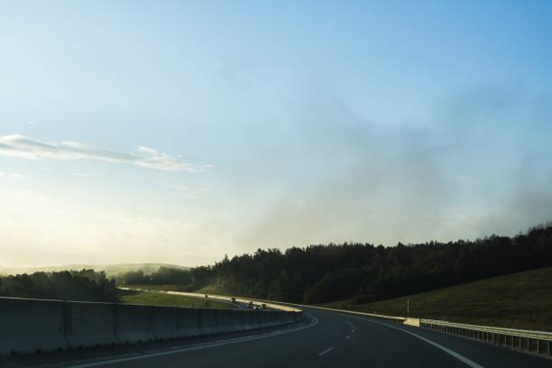 istock Misty morning sunrise on the road. 847883878
