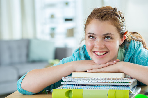 Beautiful Caucasian teenage girl smiles while daydreaming about her future.