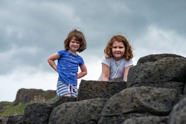 istock Siblings climbing the rocks at Giant's Causeway 847890452