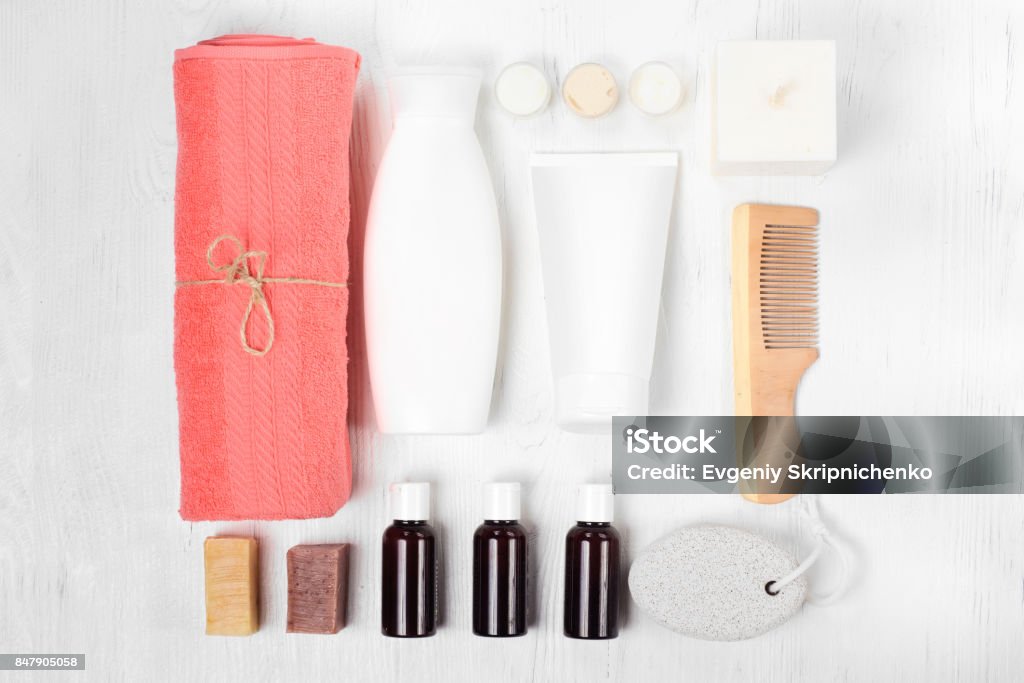 Towel cosmetics spa comb hair lotion Towel cosmetics spa comb hair lotion on white wooden background isolation Shampoo Stock Photo