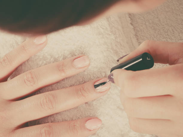 istock Woman in beauty salon getting manicure done. 847912470