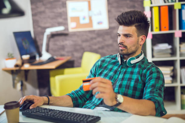 istock Man paying with credit card on computer at home office 847912628