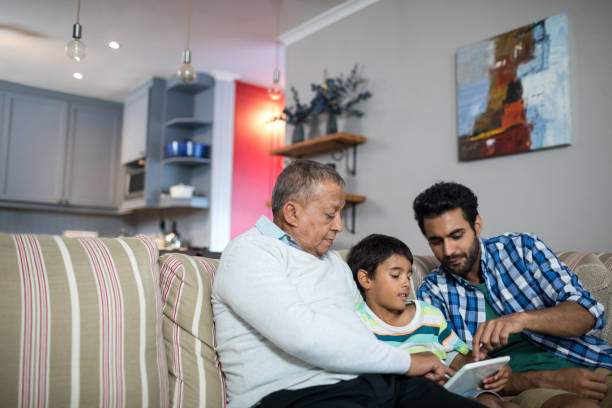 istock Father and grandfather pointing on tablet used by boy 847912982