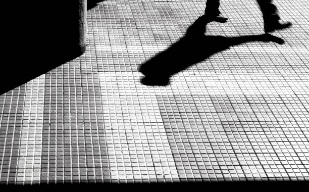 istock Silhouette and shadow of a person walking 847918140