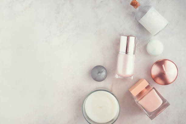 Spa beauty products on white marble table flatlay