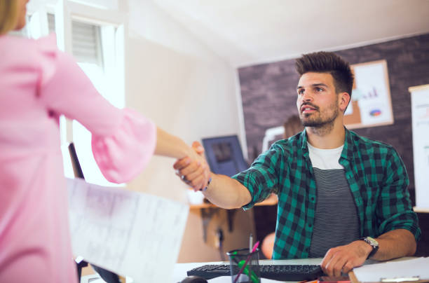 Welcome to the team! Two successful business partner shaking hands in the office casual job interview stock pictures, royalty-free photos & images