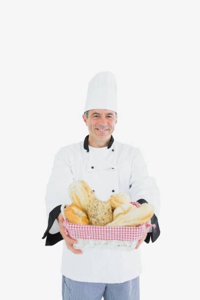 istock Male chef holding fresh breads in basket 847955410