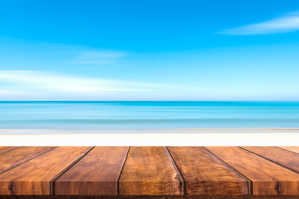 istock Wooden table sand beach blue sky 847958744