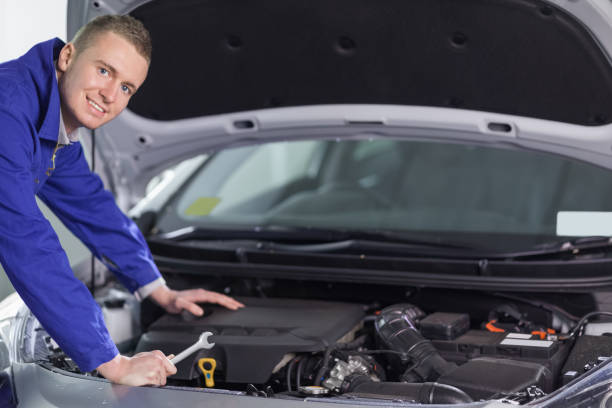 istock Mechanic leaning on a car looking at camera 847962810