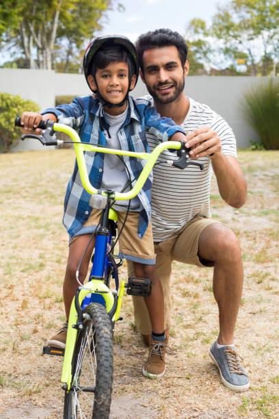 istock Portrait of father and son in yard 847963320