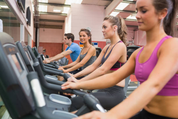 istock Women exercising on exercise bicycles 847970344