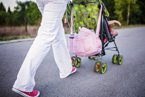 istock Young mother with a baby stroller 847974034