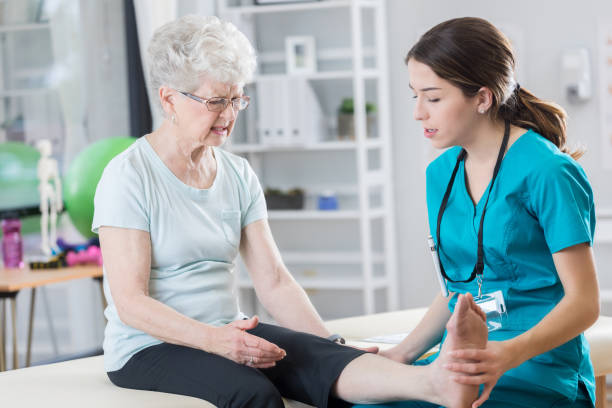 istock Young doctor examines senior patient's leg 847976942