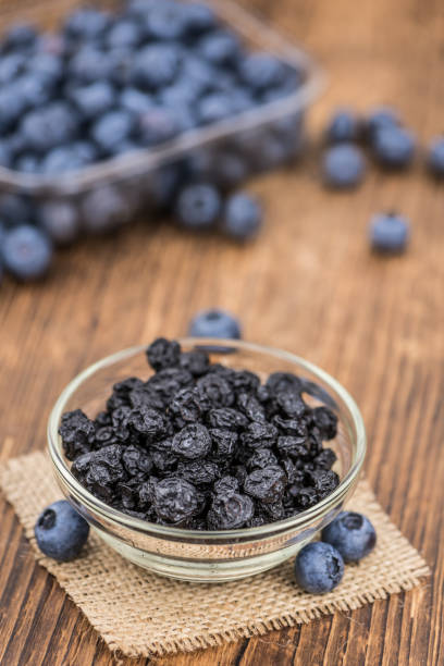 istock Portion of Dried Blueberries on wooden background, selective focus 847977646