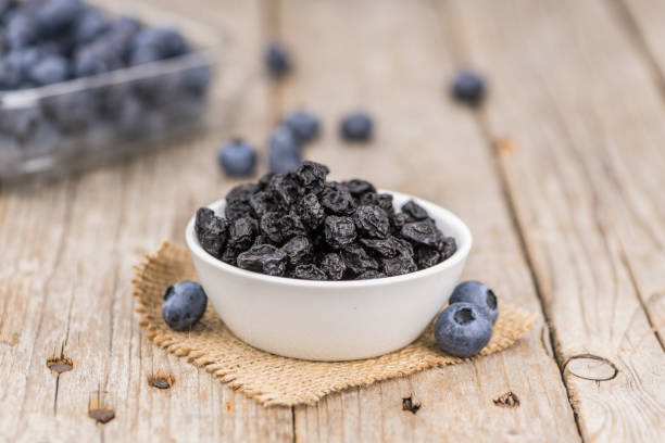 istock Portion of Dried Blueberries on wooden background, selective focus 847977728