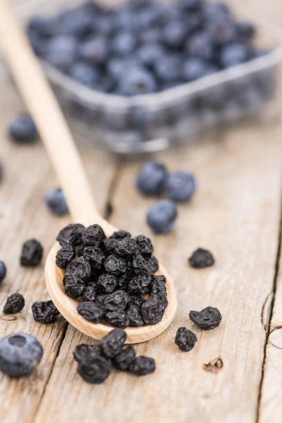 istock Portion of Dried Blueberries on wooden background, selective focus 847977848