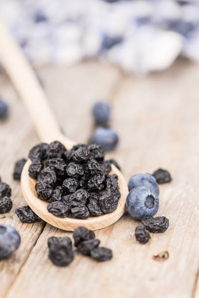 istock Portion of Dried Blueberries on wooden background, selective focus 847977926