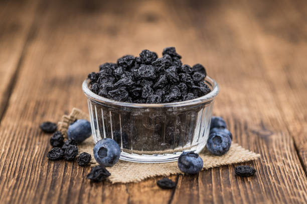 istock Portion of Dried Blueberries on wooden background, selective focus 847978130