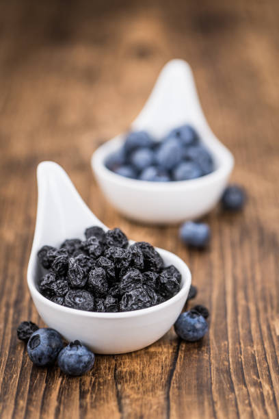 istock Dried Blueberries on wooden background; selective focus 847980904