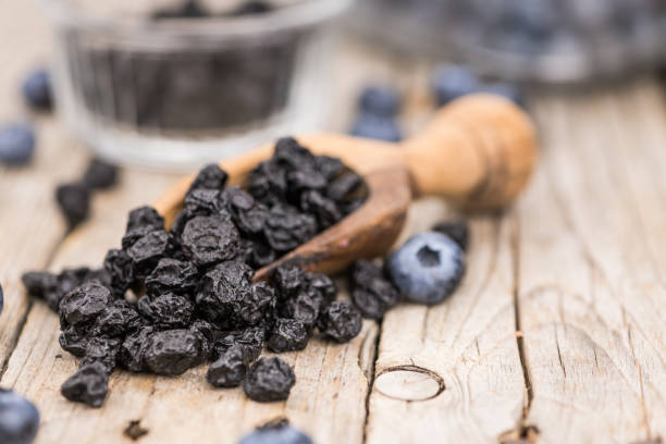 istock Dried Blueberries on wooden background; selective focus 847980990