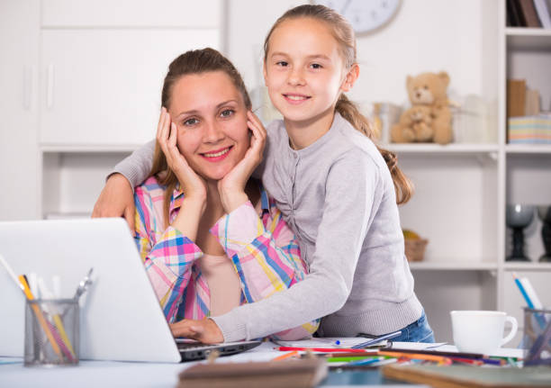istock Smiling schoolgirl and young mother 847983924