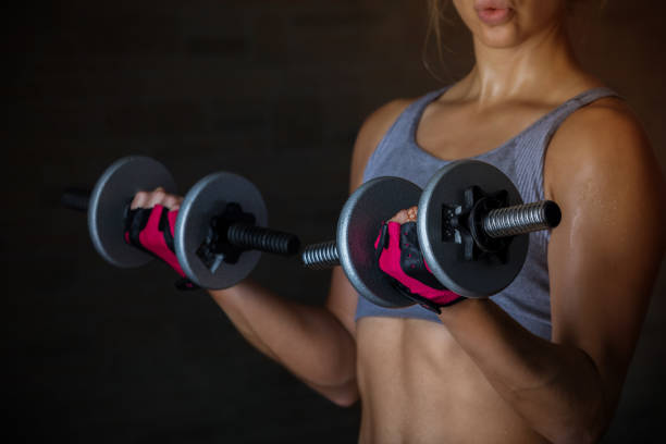 istock Strong young woman lifting weights 847984888