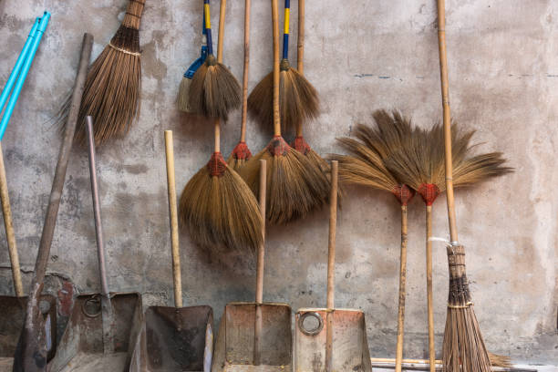 Colorful broom on the wodden wall. stock photo