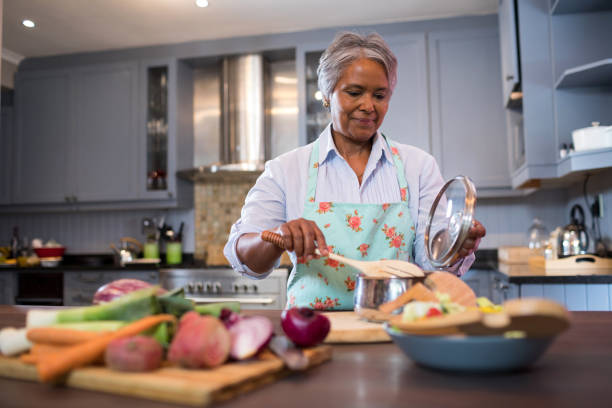 istock Senior woman preparing food in kitchen 847991662