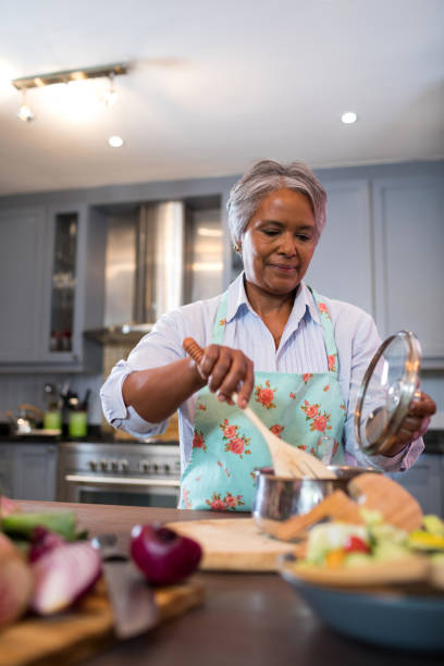 istock Senior woman making food in kitchen 847991686