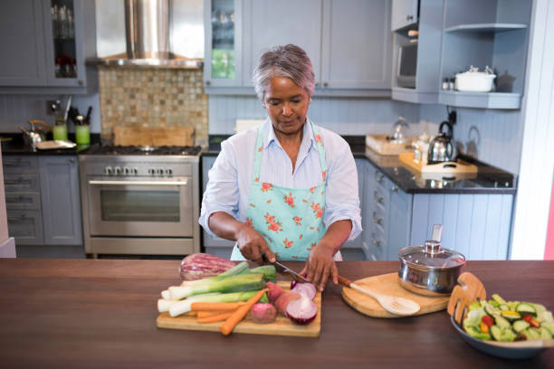 istock Woman cutting vegetables while preparing food 847991716