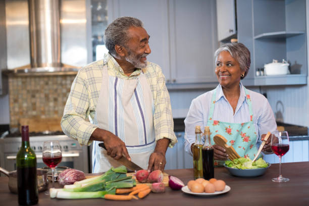 istock Smiling couple talking while preparing food at home 847991788