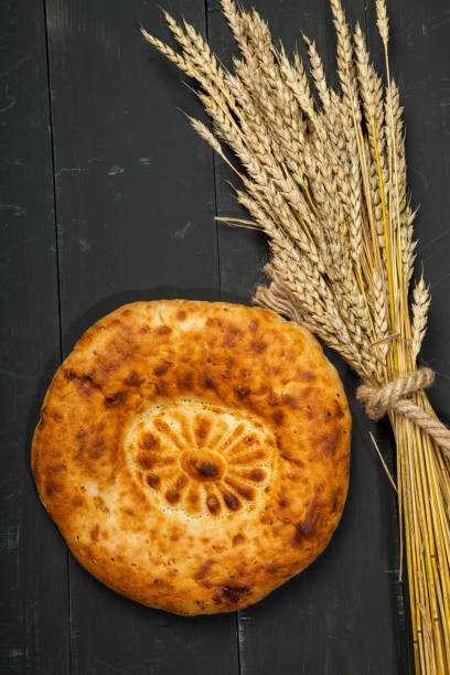 istock Bread loaf on a black wooden background 848002674