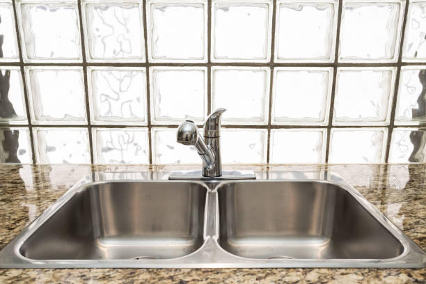 istock Chrome double kitchen sink with brick glass on the background. 848009176