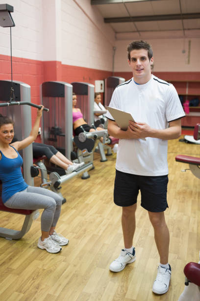 istock Man teaching his fitness class in weights room 848020118