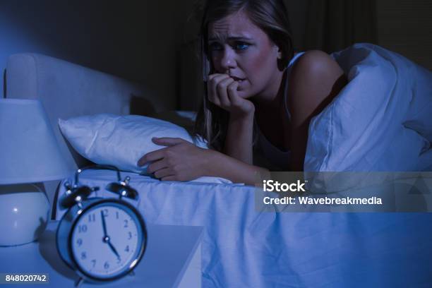Unquiet Blond Woman In The Bed At Night Stock Photo - Download Image Now - 20-24 Years, 20-29 Years, Adult