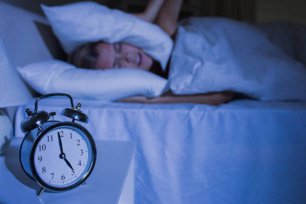 istock Upset woman putting pillows on her ears 848020788