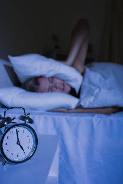istock Irritated woman putting pillows on her ears 848020872
