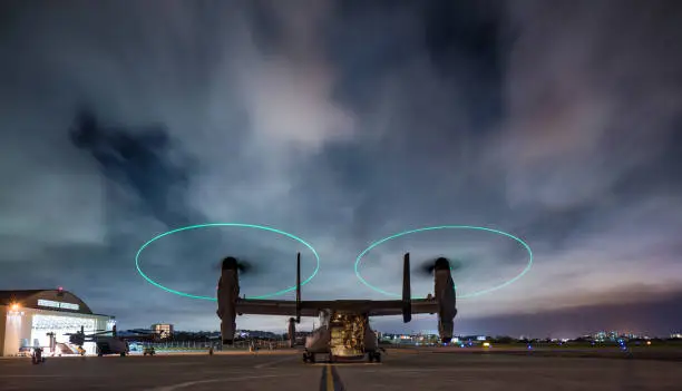 A night long exposure of a US Military V22 Osprey with clouds moving behind